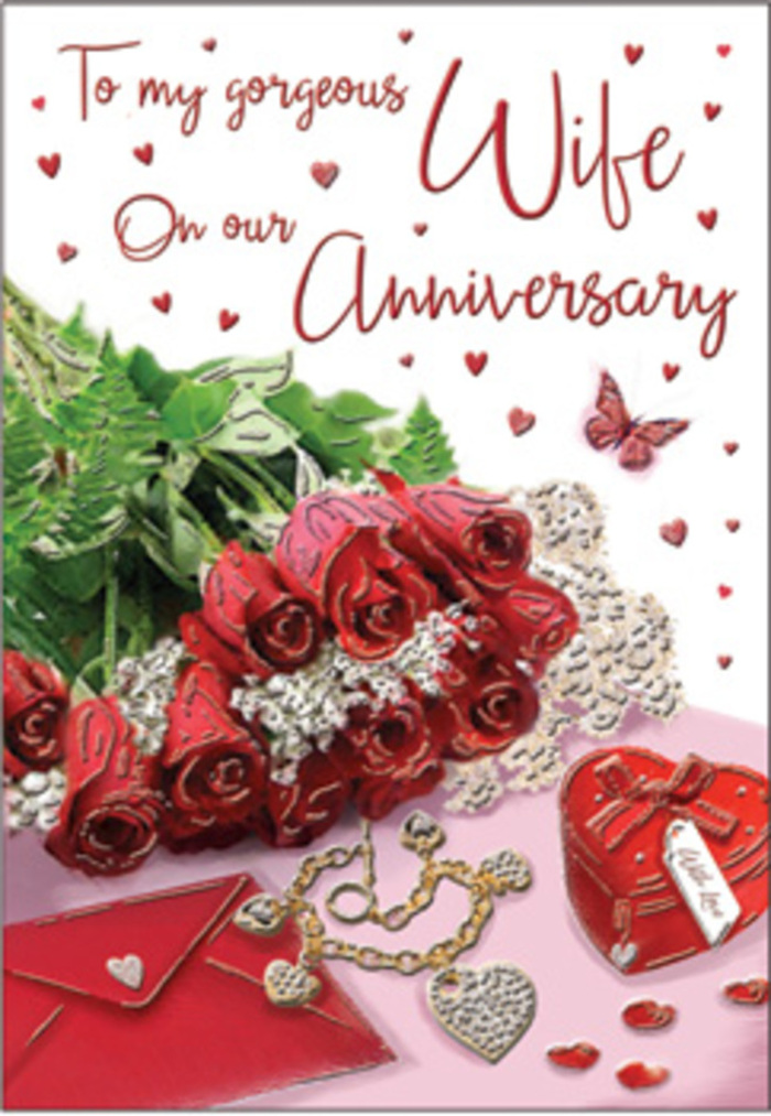The image shows a richly detailed anniversary card layout that looks as though it could be resting on a sideboard in a Norbury home, carefully styled for a moment worth remembering. At its centre is a lush gathering of classic red roses, each bloom fully developed, with layered petals that curl softly at the edges like folded silk. The roses sit low and inviting, their stems hidden beneath a cloud of fresh greenery that provides contrast and depth. This touch of foliage makes the arrangement feel alive and freshly prepared, much like a bouquet picked up from a trusted florist on London Road before a special dinner. To the right of the roses, a jewel-toned heart box in vivid red nestles on the surface, its lid smooth and slightly reflective, suggesting treasured gifts exchanged over the years. A fine piece of jewellery lies nearby, perhaps a necklace or delicate bracelet, its metal and stones catching the light in tiny, bright flashes reminiscent of evening glints along Norbury's shopfronts. Fine details continue across the card: scattered heart motifs in various sizes, some printed, some raised, and a butterfly accent that seems to hover close to the blooms, adding a sense of gentle movement. The background is warm and subtly shimmering, with hints of soft blush and cream that allow the deeper reds to stand out. Everything in the composition contributes to an atmosphere of enduring romance-textured surfaces, rich colours, and the quiet suggestion of touch and scent. This is a scene that feels tailor-made for celebrating an anniversary, where every object recalls shared milestones and promises kept.
